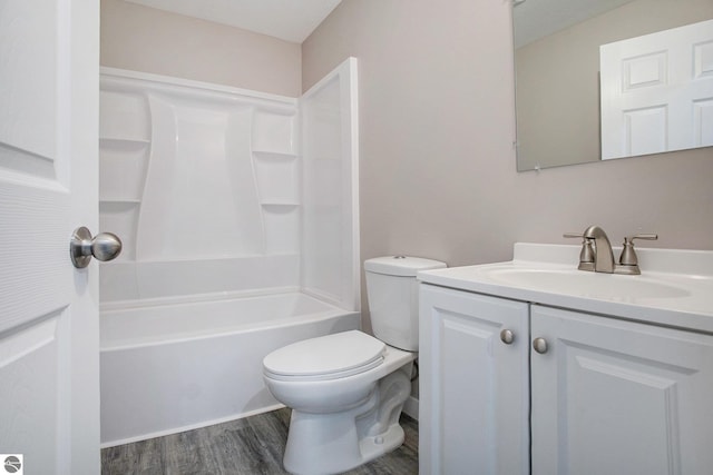 5203 NE Myers Rd, Kalkaska, MI 49646 - bathroom with toilet, wood finished floors, vanity, and shower / bath combination