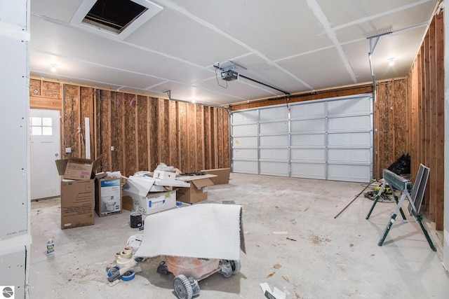 5203 NE Myers Rd, Kalkaska, MI 49646 - garage with a garage door opener and wooden walls