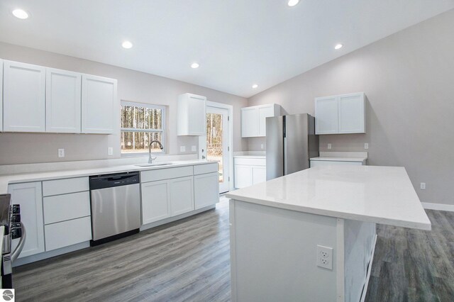 5203 NE Myers Rd, Kalkaska, MI 49646 - kitchen featuring stainless steel appliances, a sink, light wood-style floors, white cabinetry, and vaulted ceiling