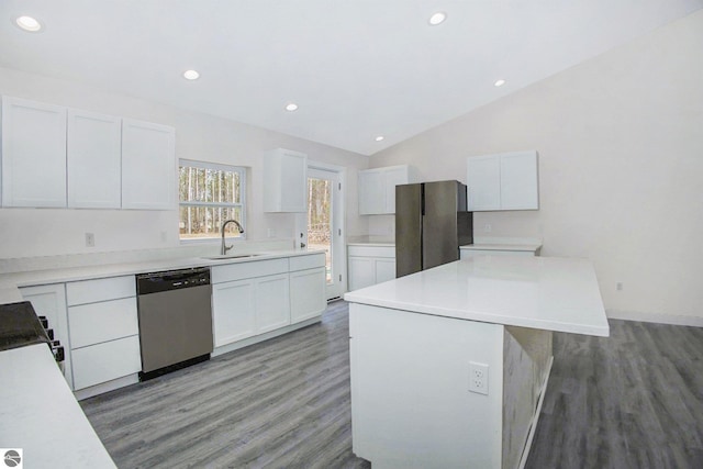 5203 NE Myers Rd, Kalkaska, MI 49646 - kitchen featuring stainless steel appliances, a sink, light wood-type flooring, vaulted ceiling, and white cabinetry