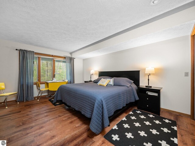 6307 Summit Ct, Traverse City, MI 49686 - bedroom featuring a textured ceiling, baseboards, and wood finished floors