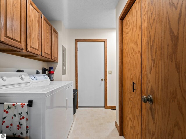 6307 Summit Ct, Traverse City, MI 49686 - clothes washing area featuring cabinet space, independent washer and dryer, electric panel, and baseboards