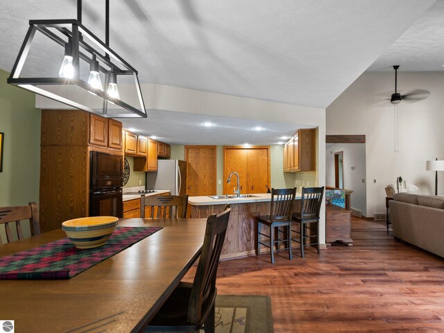 6307 Summit Ct, Traverse City, MI 49686 - dining area with wood finished floors, recessed lighting, a ceiling fan, vaulted ceiling, and baseboards