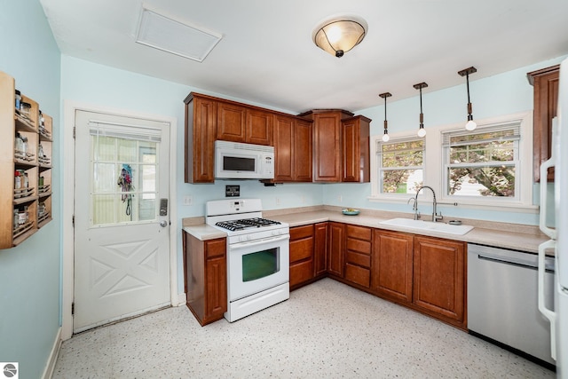 618 E Illinois St, Mount Pleasant, MI 48858 - kitchen featuring white appliances, a sink, light countertops, and brown cabinets