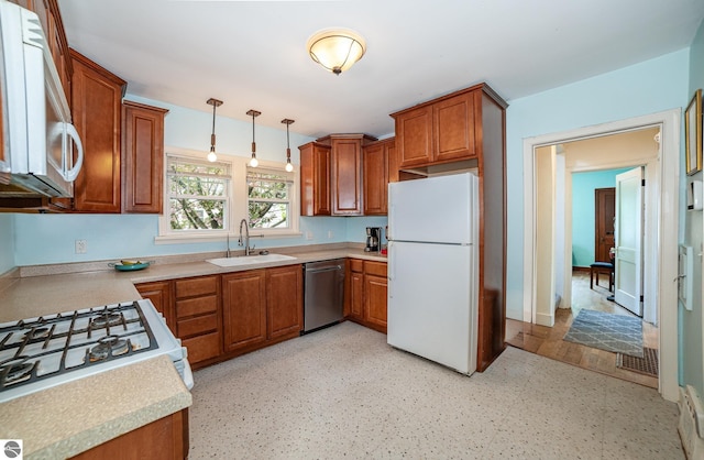 618 E Illinois St, Mount Pleasant, MI 48858 - kitchen with white appliances, a sink, brown cabinetry, and hanging light fixtures