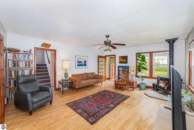 618 E Illinois St, Mount Pleasant, MI 48858 - living room with a wood stove, hardwood / wood-style floors, ceiling fan, and stairs