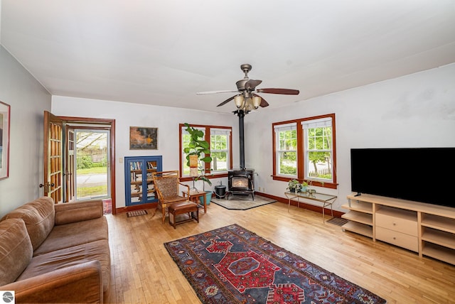 618 E Illinois St, Mount Pleasant, MI 48858 - living area with a wood stove, hardwood / wood-style floors, and ceiling fan