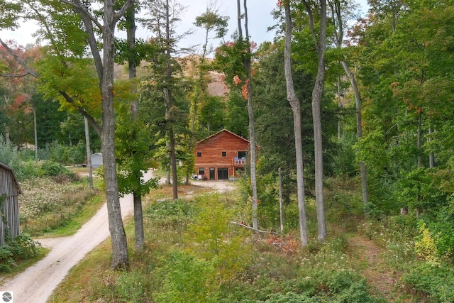 view from above of property featuring a heavily wooded area