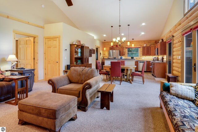 living room with light carpet, high vaulted ceiling, recessed lighting, a chandelier, and rustic walls