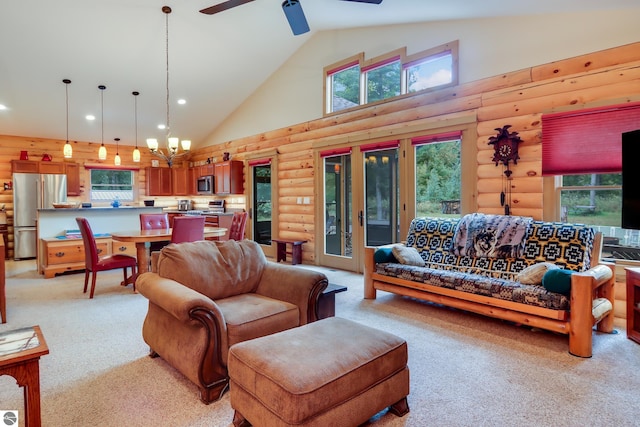living room featuring high vaulted ceiling, light colored carpet, rustic walls, ceiling fan, and recessed lighting
