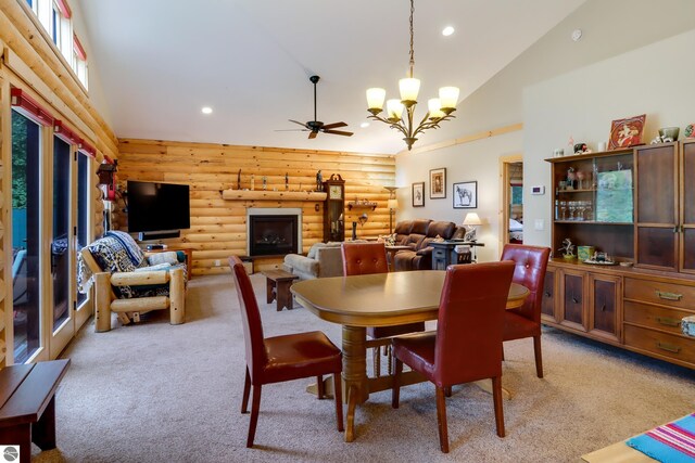 dining area with log walls, light carpet, high vaulted ceiling, a chandelier, and recessed lighting