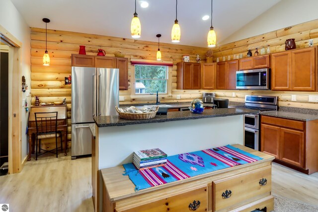 kitchen with stainless steel appliances, rustic walls, light wood finished floors, a kitchen island, and vaulted ceiling