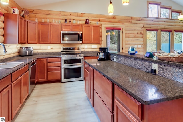 kitchen featuring appliances with stainless steel finishes, log walls, a sink, vaulted ceiling, and light wood-style floors
