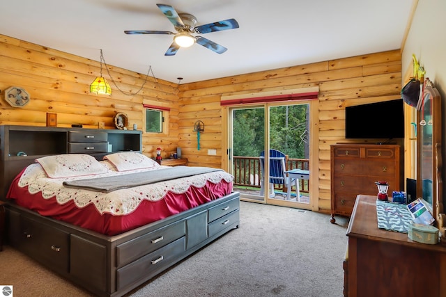 carpeted bedroom with log walls, access to exterior, and a ceiling fan