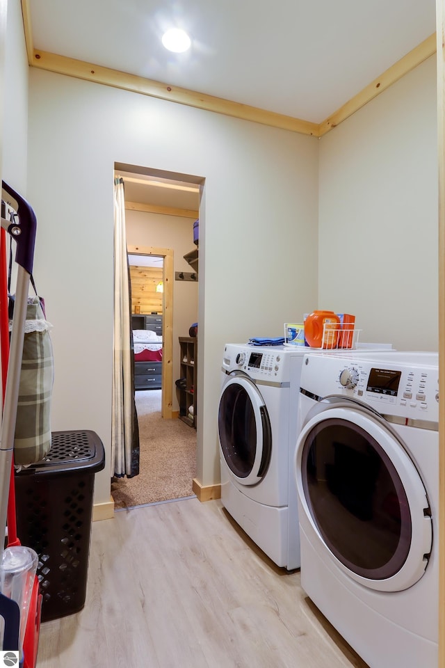 laundry area with washer and clothes dryer, wood finished floors, and recessed lighting