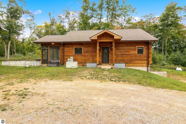 log home featuring log siding, roof with shingles, and a sunroom
