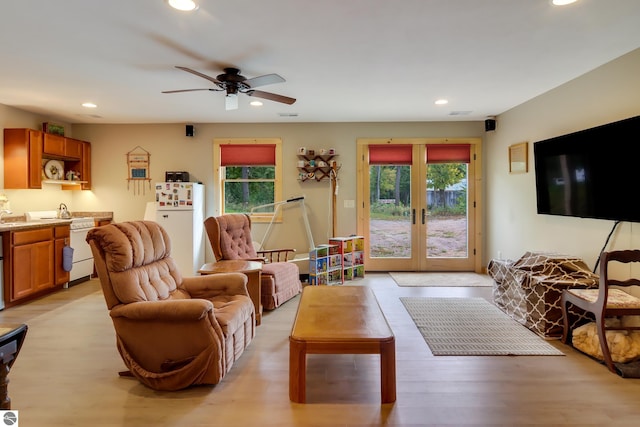 living area with plenty of natural light, recessed lighting, french doors, ceiling fan, and light wood-style flooring