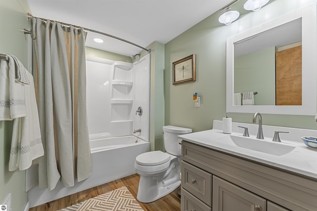 224 Island View Dr, Traverse City, MI 49696 - bathroom with wood finished floors, toilet, washtub / shower combination, and vanity