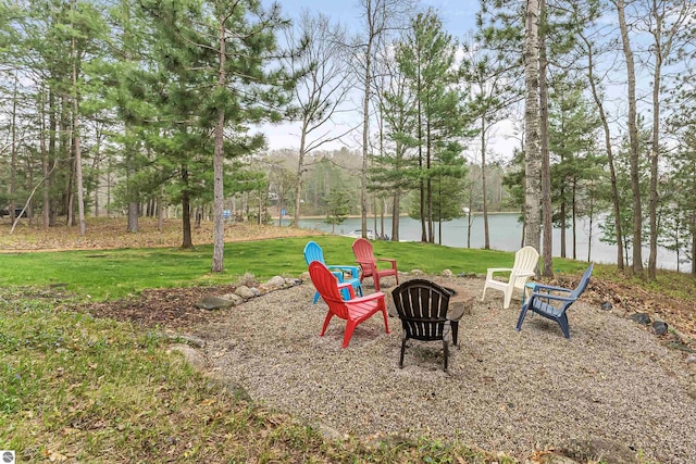 224 Island View Dr, Traverse City, MI 49696 - view of green lawn featuring a fire pit and a water view