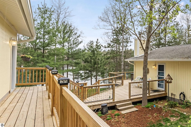 224 Island View Dr, Traverse City, MI 49696 - wooden terrace with a water view and view of wooded area