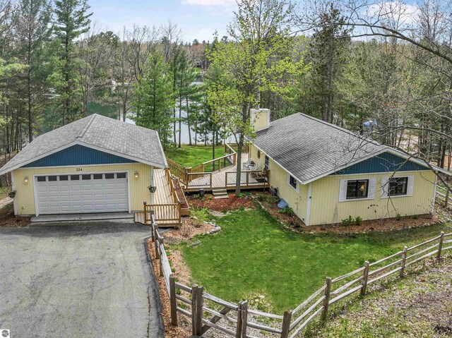 224 Island View Dr, Traverse City, MI 49696 - view of property exterior with roof with shingles, a wooden deck, and a detached garage