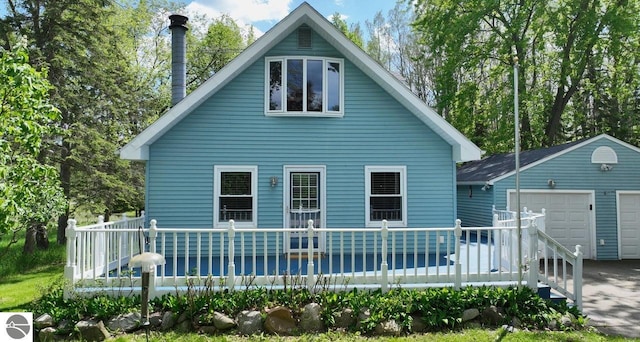 1117 Lincoln Dr, Lake Isabella, MI 48893 - rear view of property with an outbuilding and a wooden deck