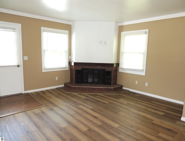 1117 Lincoln Dr, Lake Isabella, MI 48893 - unfurnished living room with a glass covered fireplace, wood finished floors, and baseboards