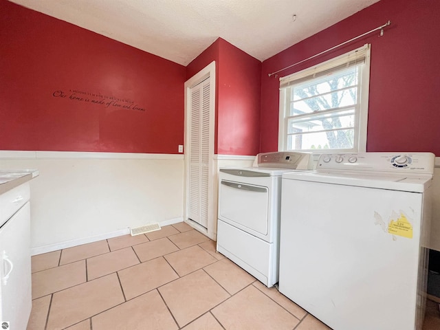 660 N Michigan Ave, Manton, MI 49663 - laundry room featuring washing machine and dryer, light tile patterned flooring, and cabinet space