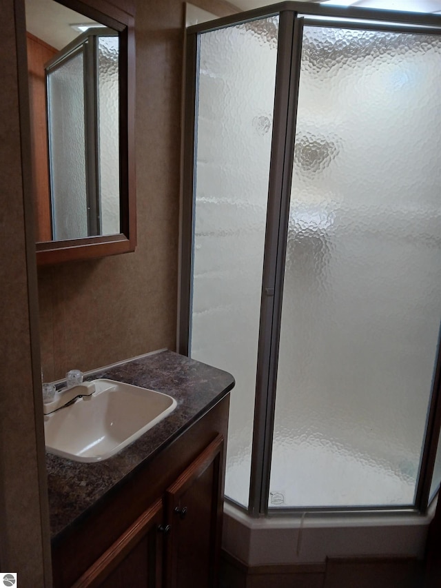 1392 Kitchen Rd, Whittemore, MI 48770 - full bathroom featuring a stall shower and vanity