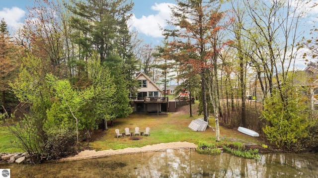 5467 Lakeview Dr, Interlochen, MI 49643 - view of grassy yard with a wooden deck