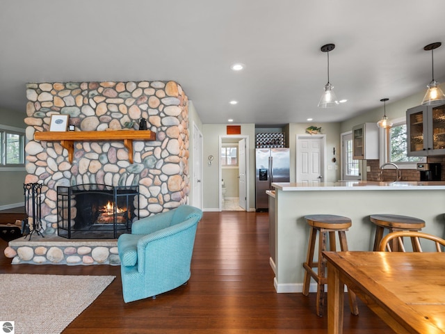 5467 Lakeview Dr, Interlochen, MI 49643 - living room with baseboards, dark wood finished floors, recessed lighting, and a fireplace