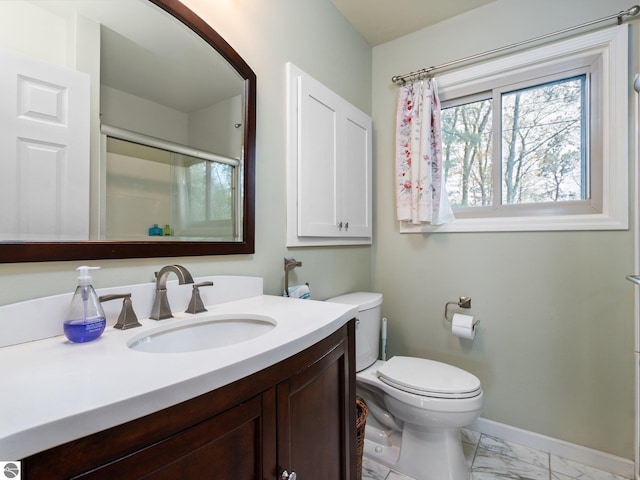 5467 Lakeview Dr, Interlochen, MI 49643 - bathroom featuring marble look tile flooring, baseboards, vanity, toilet, and a shower with shower door