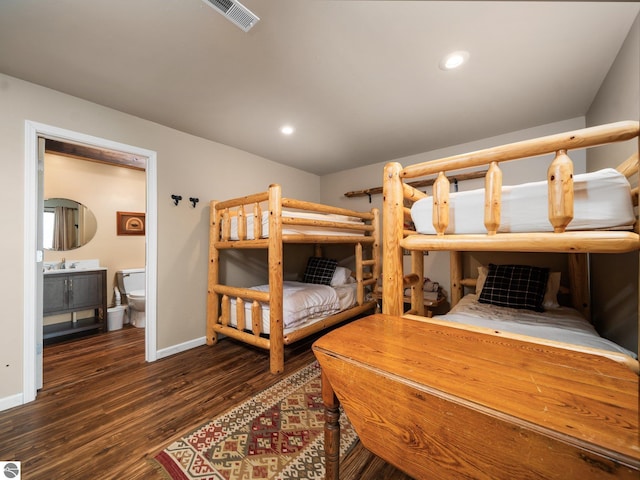 5467 Lakeview Dr, Interlochen, MI 49643 - bedroom with wood finished floors, baseboards, connected bathroom, and recessed lighting