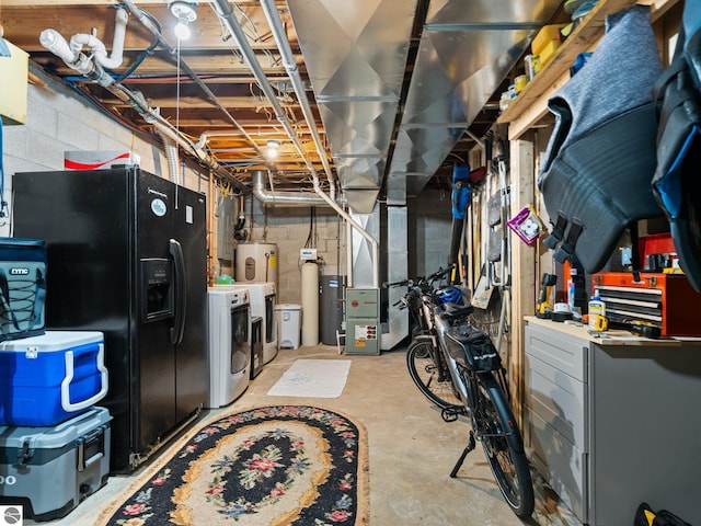 5467 Lakeview Dr, Interlochen, MI 49643 - unfinished below grade area featuring washing machine and clothes dryer, black fridge, heating unit, and a water softener system