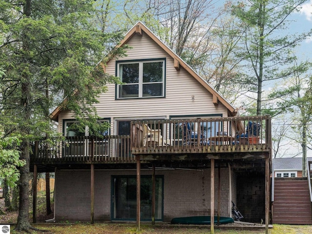 5467 Lakeview Dr, Interlochen, MI 49643 - rear view of house featuring a wooden deck