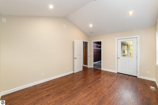 11749 Birch Dr, Lakeview, MI 48850 - unfurnished bedroom with wood finished floors, vaulted ceiling, baseboards, recessed lighting, and a walk in closet