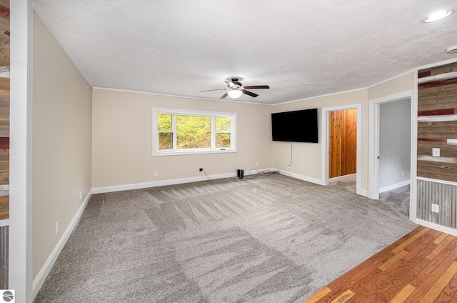 11749 Birch Dr, Lakeview, MI 48850 - carpeted empty room featuring ceiling fan, a textured ceiling, baseboards, ornamental molding, and wood finished floors