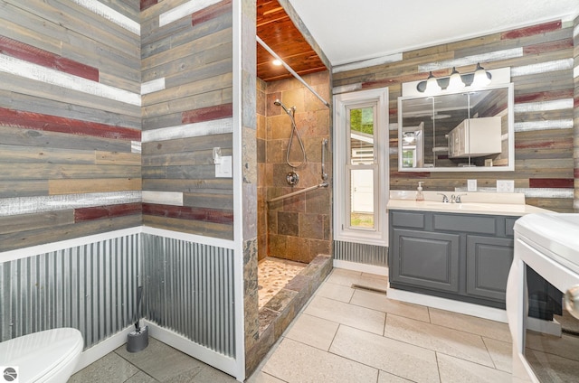 11749 Birch Dr, Lakeview, MI 48850 - full bath with toilet, a tile shower, wooden walls, vanity, and tile patterned flooring