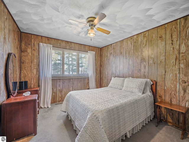 11401 Orchard Dr, Rapid City, MI 48622 - bedroom with carpet floors, wood walls, and ceiling fan