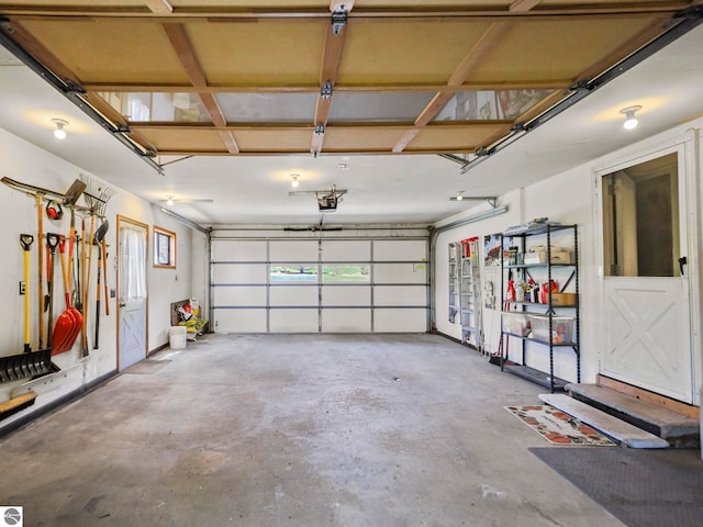 11401 Orchard Dr, Rapid City, MI 48622 - garage featuring a garage door opener