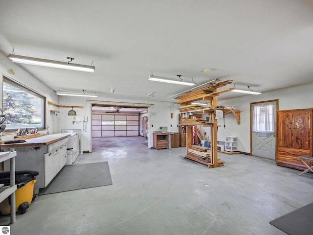 11401 Orchard Dr, Rapid City, MI 48622 - garage featuring a workshop area