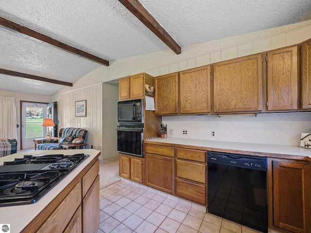 11401 Orchard Dr, Rapid City, MI 48622 - kitchen with black appliances, a textured ceiling, light countertops, light tile patterned floors, and brown cabinets