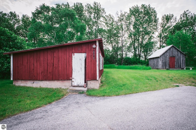 1435 S French Rd, Lake Leelanau, MI 49653 - view of outbuilding with an outbuilding and view of wooded area