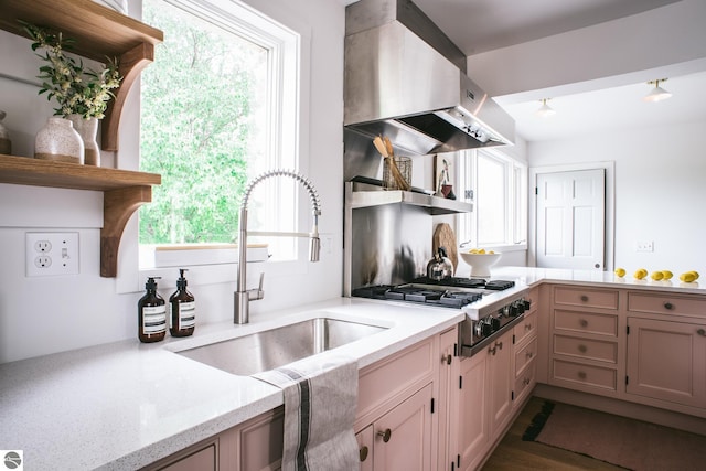 1435 S French Rd, Lake Leelanau, MI 49653 - kitchen featuring wall chimney exhaust hood, a sink, open shelves, light stone countertops, and a peninsula