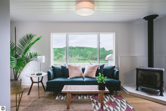 1435 S French Rd, Lake Leelanau, MI 49653 - living room with a wood stove, light wood-type flooring, crown molding, and wooden ceiling