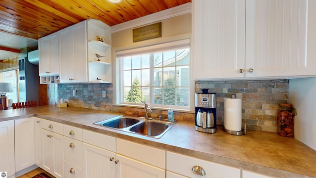 10701 SW Torch Lake Dr, Rapid City, MI 49676 - kitchen featuring a sink, wooden ceiling, open shelves, white cabinets, and decorative backsplash