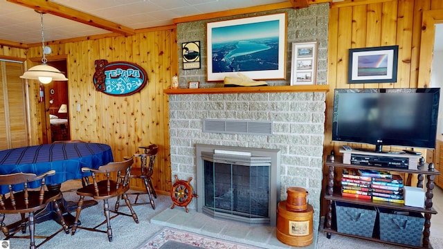 10701 SW Torch Lake Dr, Rapid City, MI 49676 - carpeted living area with wood walls and a glass covered fireplace