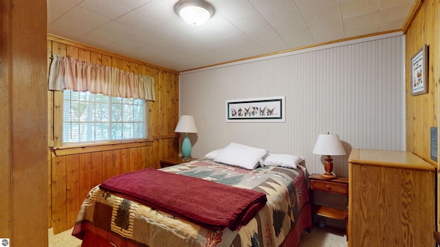 10701 SW Torch Lake Dr, Rapid City, MI 49676 - carpeted bedroom featuring wood walls and ornamental molding