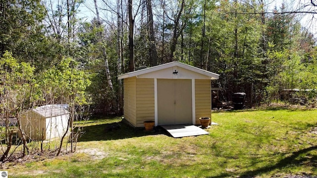 10701 SW Torch Lake Dr, Rapid City, MI 49676 - view of shed with a view of trees