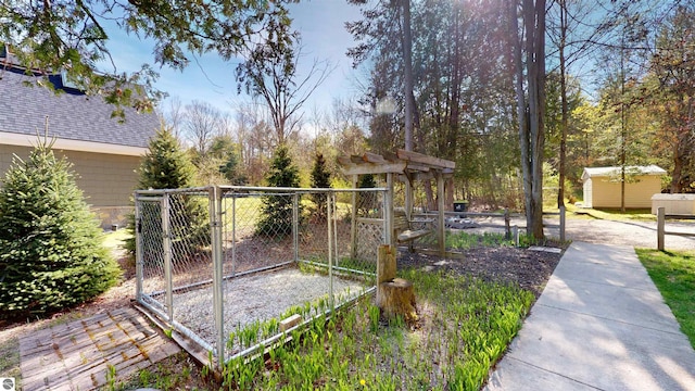 10701 SW Torch Lake Dr, Rapid City, MI 49676 - view of yard with a gate, an outbuilding, and fence